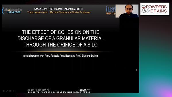 The effect of cohesion on the discharge of a granular material through the orifice of a silo