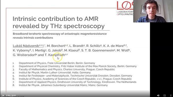 Broadband terahertz spectroscopy of anisotropic magnetoresistance reveals intrinsic contributions